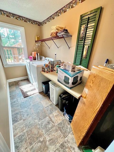 19 Magnolia Ct NE, Rydal, GA 30171 - laundry room with washer and dryer, baseboards, a textured ceiling, and stone finish flooring