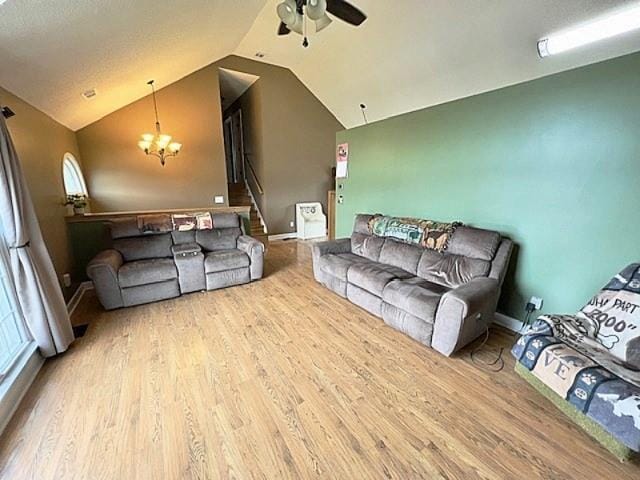 19 Magnolia Ct NE, Rydal, GA 30171 - living room featuring vaulted ceiling, ceiling fan, wood finished floors, a chandelier, and stairway