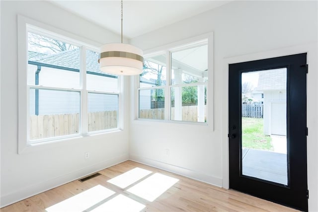 3395 Lee St, East Point, GA 30344 - unfurnished dining area with light wood-style flooring, a healthy amount of sunlight, and visible vents