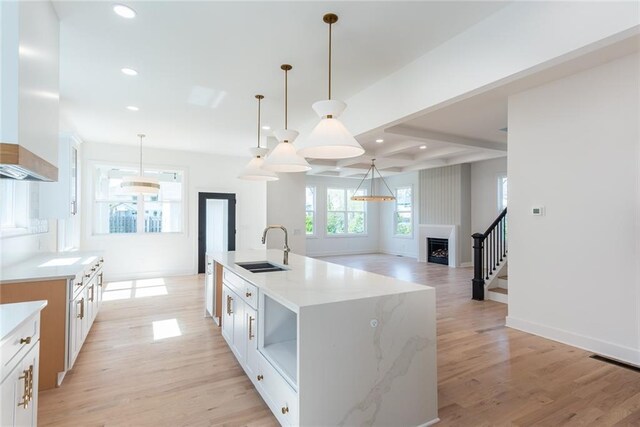 3395 Lee St, East Point, GA 30344 - kitchen featuring light wood finished floors, recessed lighting, wall chimney exhaust hood, and a sink