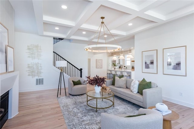 3395 Lee St, East Point, GA 30344 - living area featuring stairway, baseboards, visible vents, and light wood finished floors