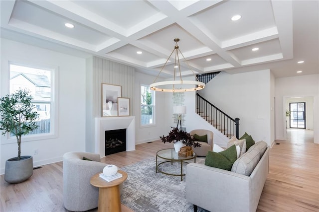 3395 Lee St, East Point, GA 30344 - living area with a chandelier, coffered ceiling, stairs, and light wood-style floors
