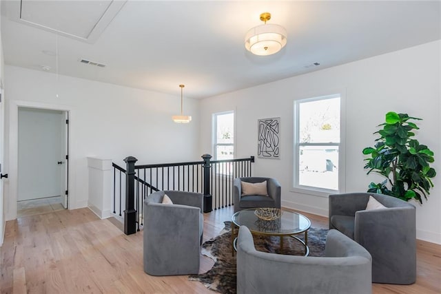 3395 Lee St, East Point, GA 30344 - sitting room featuring attic access, light wood-style flooring, an upstairs landing, and baseboards