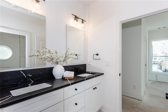 3395 Lee St, East Point, GA 30344 - bathroom featuring double vanity, visible vents, baseboards, and a sink