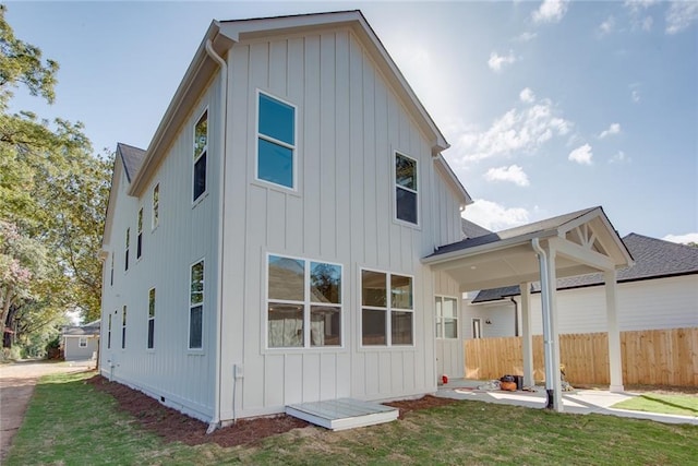 3395 Lee St, East Point, GA 30344 - rear view of house with a lawn, board and batten siding, and fence