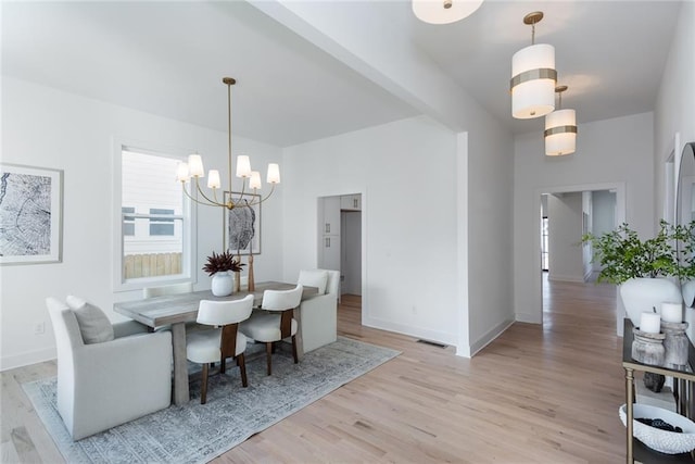 3395 Lee St, East Point, GA 30344 - dining space with light wood-style flooring, a notable chandelier, visible vents, and baseboards
