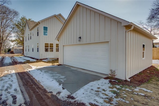 3395 Lee St, East Point, GA 30344 - view of front facade featuring a garage, board and batten siding, and driveway