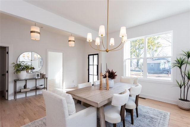 3395 Lee St, East Point, GA 30344 - dining room featuring visible vents, baseboards, lofted ceiling, light wood-type flooring, and a chandelier