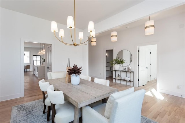 3395 Lee St, East Point, GA 30344 - dining room featuring a notable chandelier, light wood-style floors, and baseboards