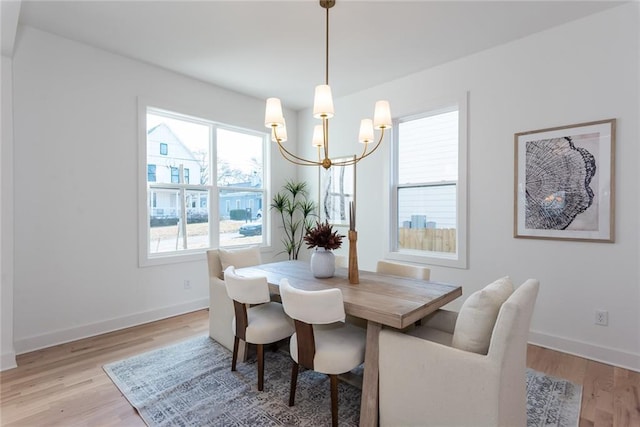 3395 Lee St, East Point, GA 30344 - dining room featuring baseboards, an inviting chandelier, and light wood finished floors