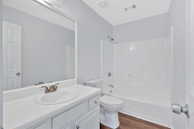 full bathroom featuring toilet, vanity, and tub / shower combination