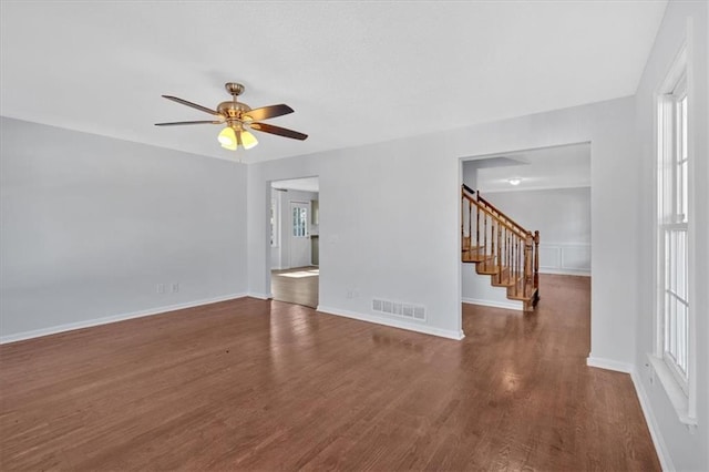 unfurnished room featuring ceiling fan and dark wood-type flooring