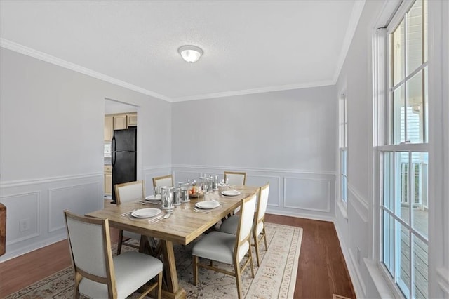 dining room featuring dark wood-type flooring and ornamental molding