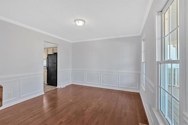 unfurnished room featuring hardwood / wood-style floors and crown molding