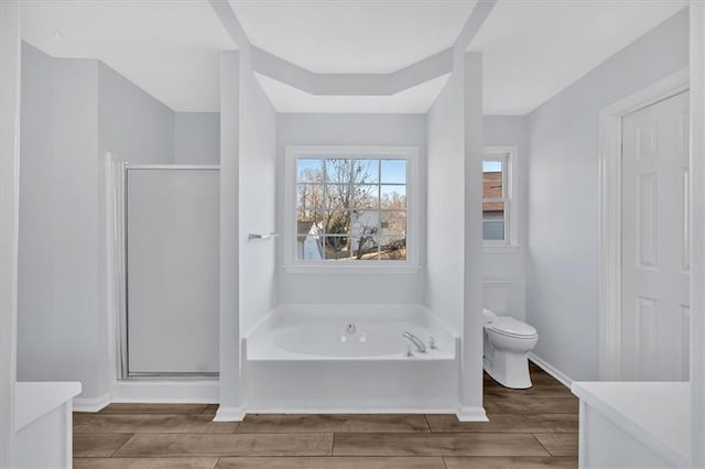 bathroom featuring toilet and shower with separate bathtub