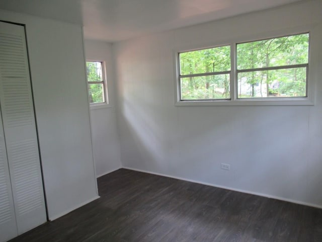 1779 New Bridge Rd, Cleveland, GA 30528 - unfurnished bedroom with dark wood-style floors, baseboards, and a closet