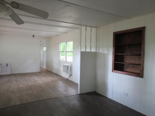 1779 New Bridge Rd, Cleveland, GA 30528 - unfurnished room with wood finished floors, a wall mounted AC, a ceiling fan, radiator, and beamed ceiling