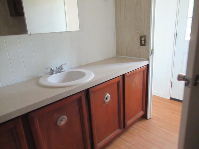 1779 New Bridge Rd, Cleveland, GA 30528 - bathroom with wood finished floors, backsplash, and vanity