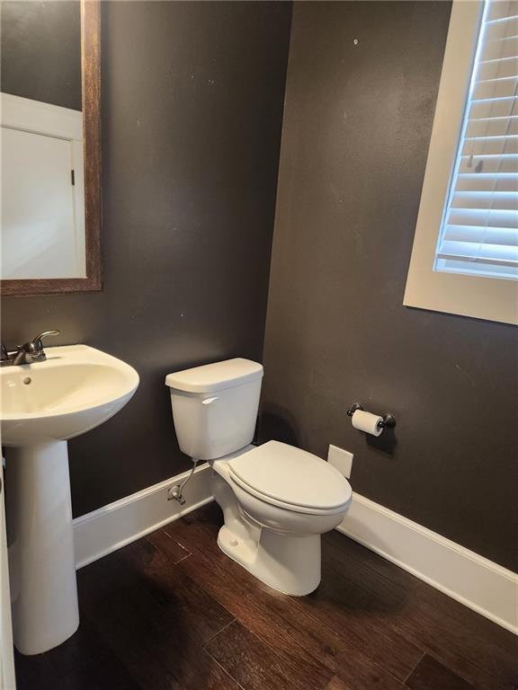 2439 Muirfield Pl, Atlanta, GA 30337 - bathroom featuring wood finished floors, baseboards, toilet, and a sink