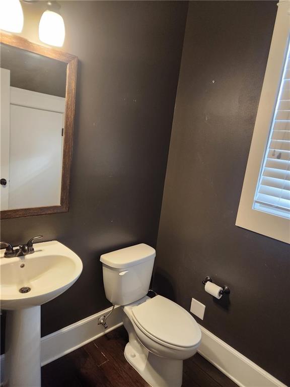 2439 Muirfield Pl, Atlanta, GA 30337 - half bath with baseboards, toilet, and wood finished floors