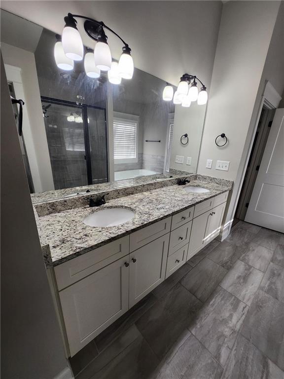 2439 Muirfield Pl, Atlanta, GA 30337 - bathroom with a garden tub, a shower stall, and double vanity