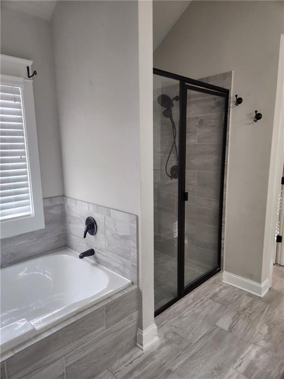 2439 Muirfield Pl, Atlanta, GA 30337 - full bathroom featuring a stall shower, a bath, and baseboards