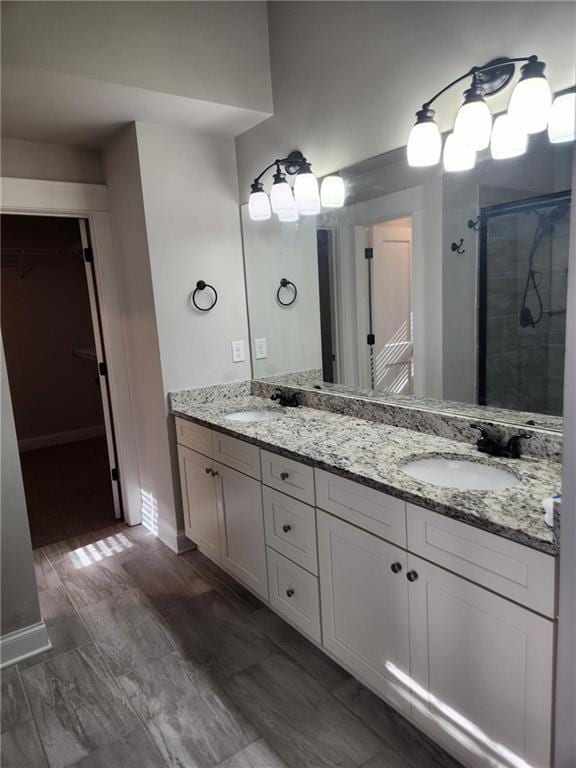 2439 Muirfield Pl, Atlanta, GA 30337 - bathroom with a spacious closet, a shower stall, and double vanity