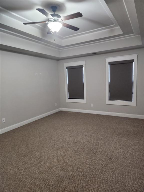2439 Muirfield Pl, Atlanta, GA 30337 - carpeted empty room with a raised ceiling, baseboards, and ceiling fan
