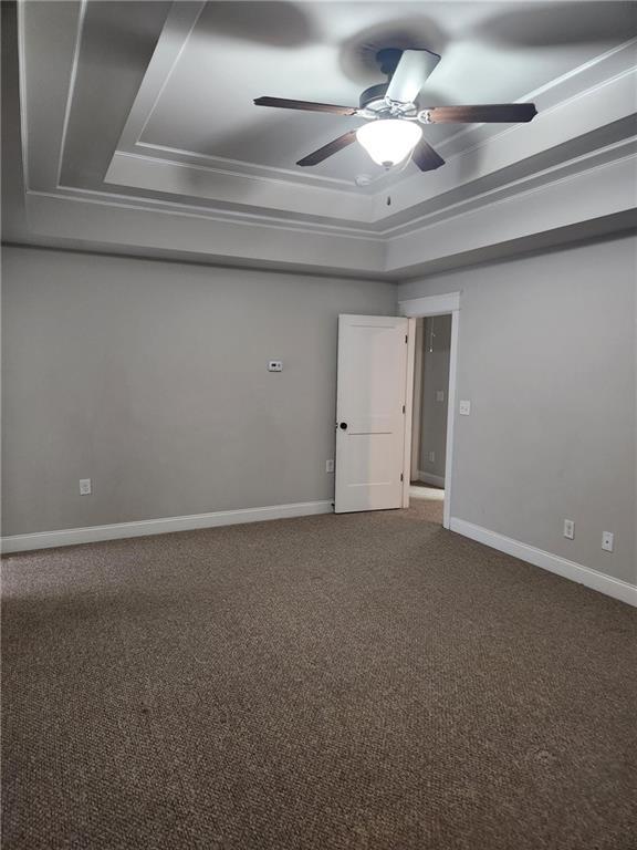 2439 Muirfield Pl, Atlanta, GA 30337 - spare room with a tray ceiling, ceiling fan, carpet flooring, and baseboards