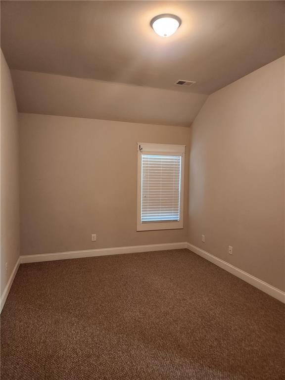 2439 Muirfield Pl, Atlanta, GA 30337 - spare room with lofted ceiling, dark colored carpet, and baseboards