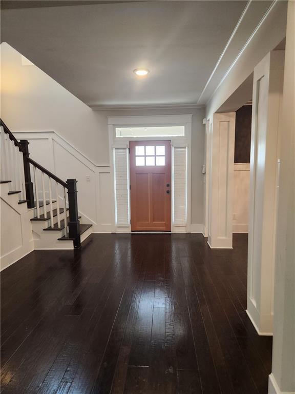 2439 Muirfield Pl, Atlanta, GA 30337 - foyer entrance with hardwood / wood-style floors, stairs, and baseboards