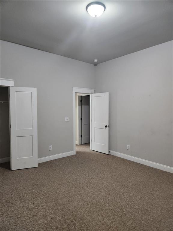 2439 Muirfield Pl, Atlanta, GA 30337 - unfurnished bedroom with carpet, baseboards, and a closet