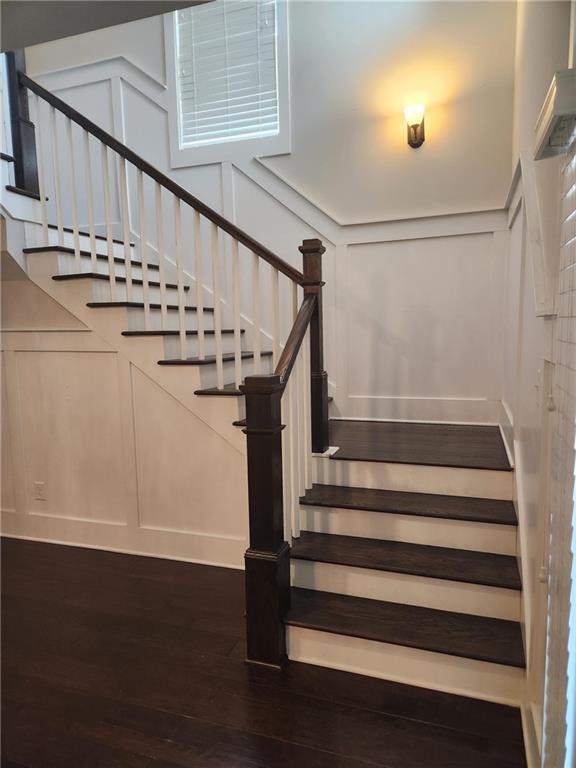 2439 Muirfield Pl, Atlanta, GA 30337 - stairway with a decorative wall and wood finished floors
