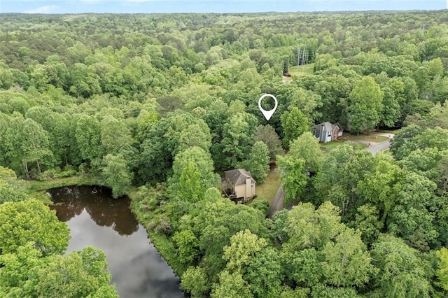 drone / aerial view featuring a water view and a forest view