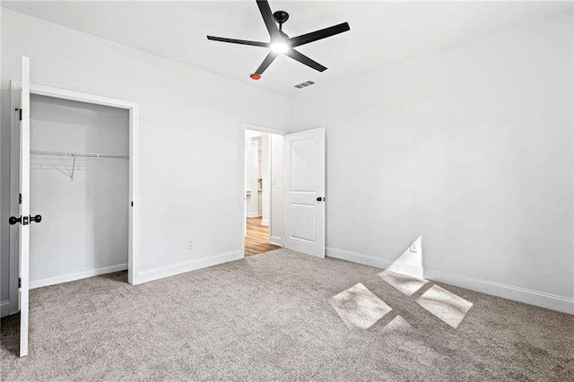 unfurnished bedroom featuring a closet, visible vents, baseboards, and carpet flooring