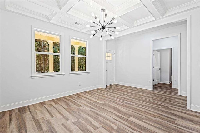 unfurnished room featuring a chandelier, beamed ceiling, baseboards, and wood finished floors