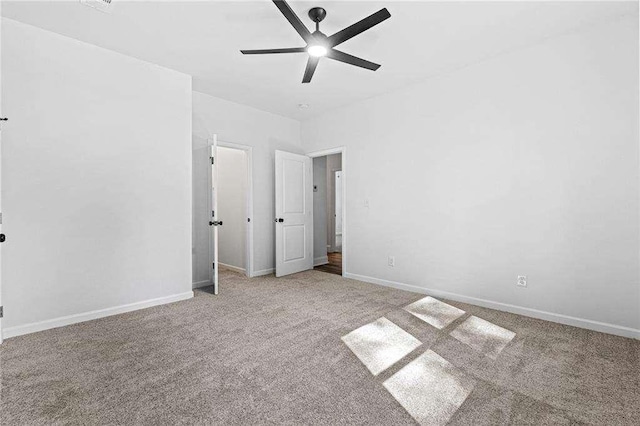 unfurnished bedroom with ceiling fan, baseboards, and carpet flooring