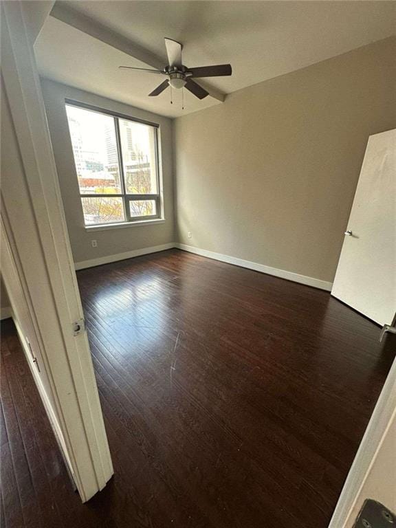 unfurnished room with dark hardwood / wood-style floors and ceiling fan