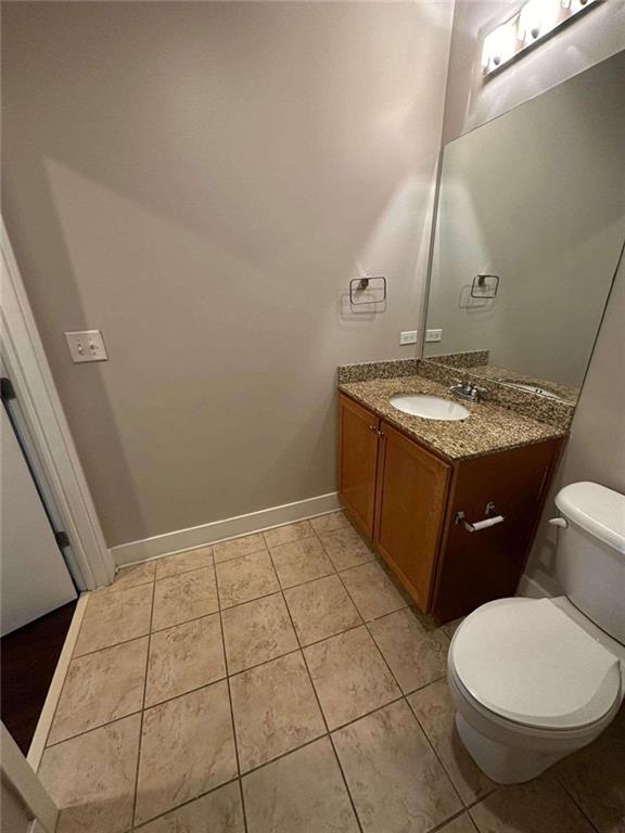 bathroom with tile patterned flooring, tiled shower / bath combo, and toilet