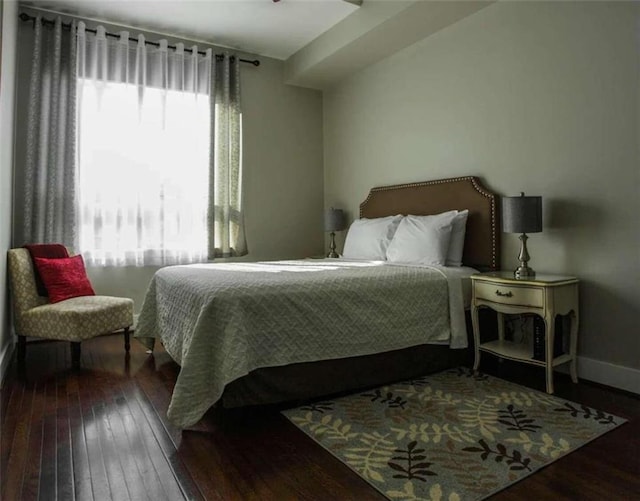 bedroom with dark wood-type flooring