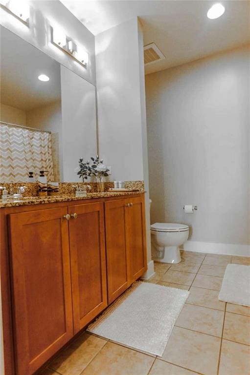 bathroom featuring a shower with curtain, vanity, tile patterned flooring, and toilet