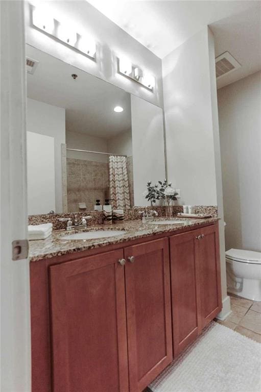 bathroom with vanity, tile patterned floors, toilet, and a shower with shower curtain