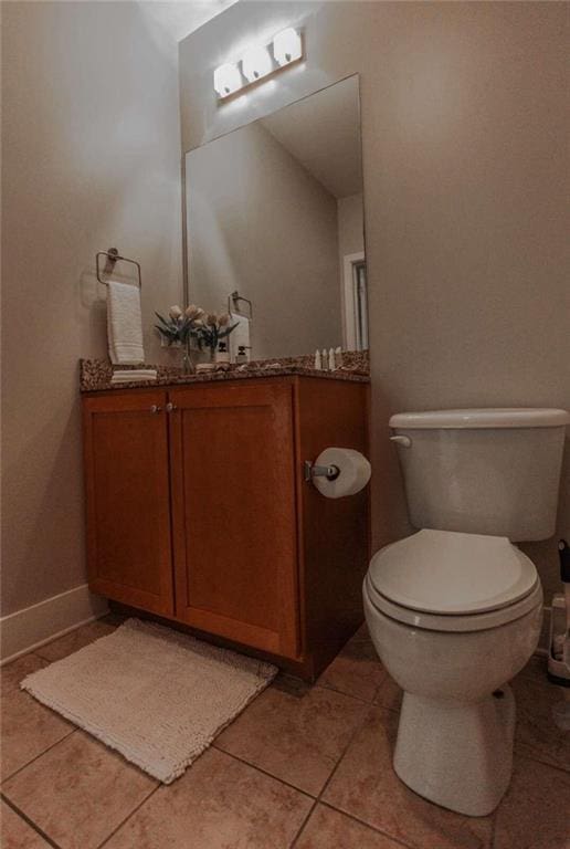 bathroom with tile patterned flooring, vanity, and toilet