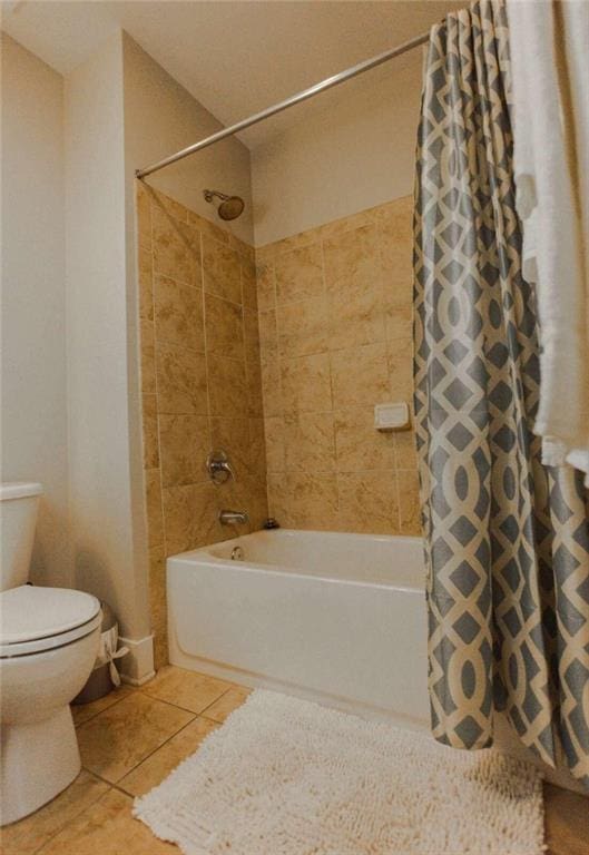 bathroom with shower / bath combination with curtain, tile patterned floors, and toilet