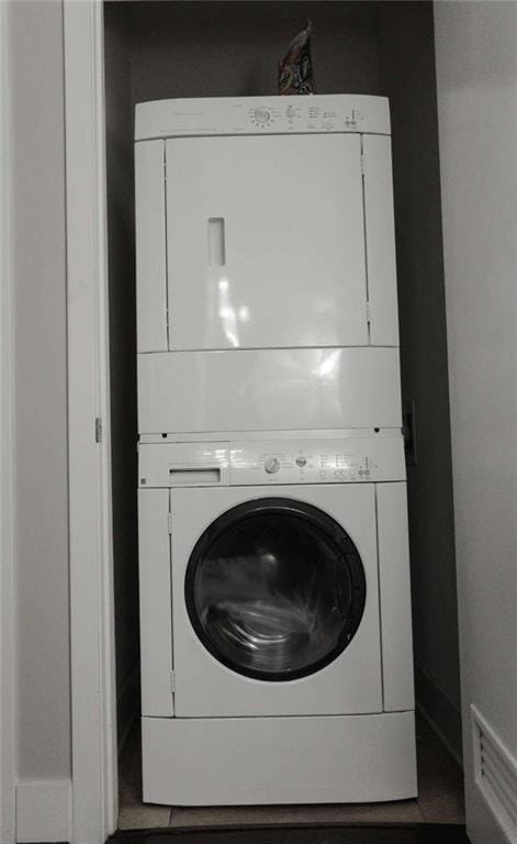 laundry area featuring stacked washer and clothes dryer