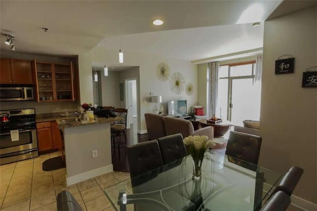 dining area featuring light tile patterned flooring and sink