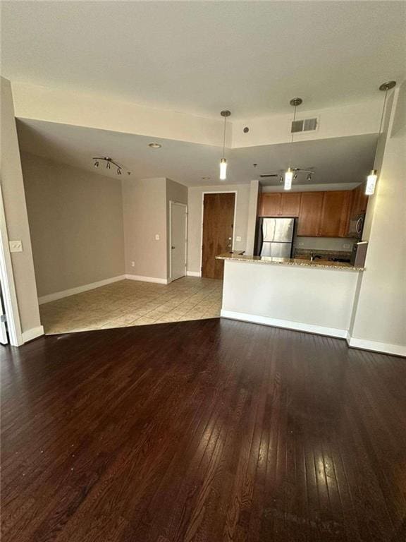 unfurnished living room with dark wood-type flooring