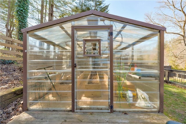 view of greenhouse with fence