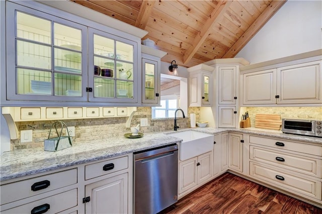 kitchen with decorative backsplash, dishwasher, lofted ceiling with beams, glass insert cabinets, and a sink