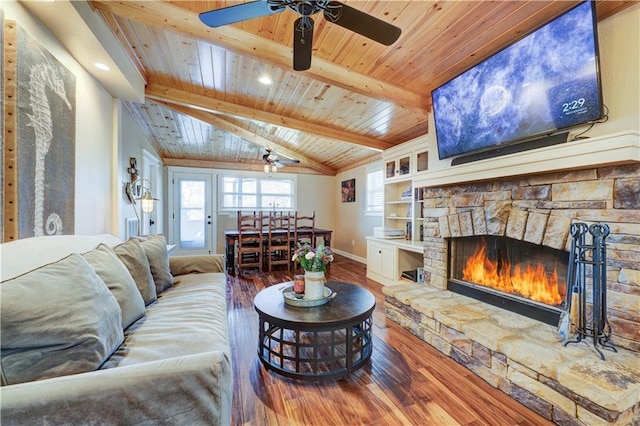 living room featuring baseboards, lofted ceiling with beams, wood ceiling, wood finished floors, and a fireplace